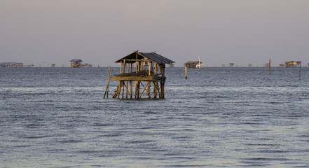 Lonely small house without window and door in the sea