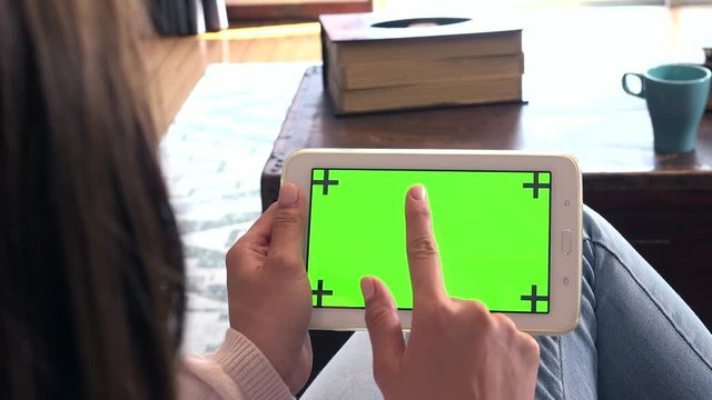Japanese teen sitting on sofa, female teenager at home. Asian girl as college student using ipad, young woman with digital tablet. Pc monitor and computer green screen for internet and social media