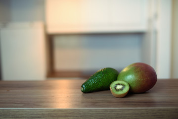 Avocado, mango and kiwi on the table. Healthy vegetarian lifestyle concept. Copy space