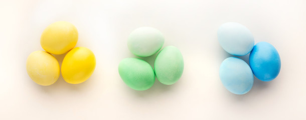 Easter background. Colored eggs on white, isolated