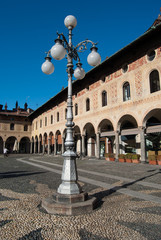 Piazza Ducale with original greek frescoes  on historic buildings and typical street lamp in...