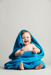 Smiling baby tucked in a warm blanket