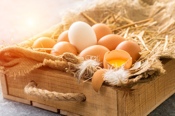 bunch of fresh brown eggs  in a wooden crate
