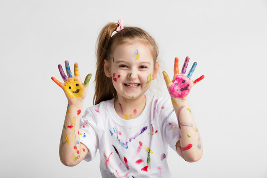 Young kid showing her colorful hands