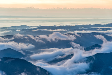 Fototapeta na wymiar Beautiful mountain view with fog over the peaks at sunrise, Ceahlau massif, Eastern Carpathians, Moldova, Romania