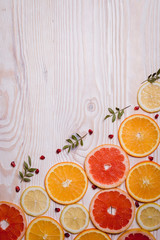 Citrus fruit cut in half - oranges, lemons, tangerines, grapefruit on a wooden background