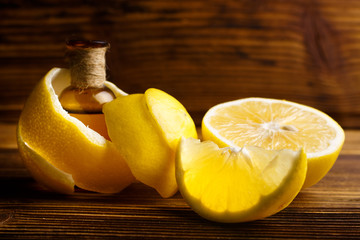 Lemon essential oil on a wooden background