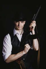 Man on a black background with a gun