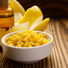 Lemon essential oil on a wooden background