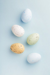 Easter eggs selection on a pastel blue background viewed from above. Top view. Copy space