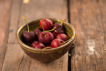 Bowl of Cherries. Red cherries in a bowl on wooden background