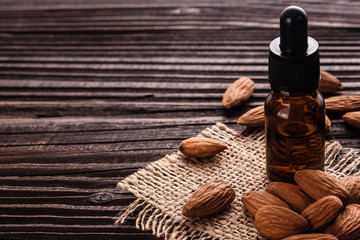 almond essential oil on a wooden background