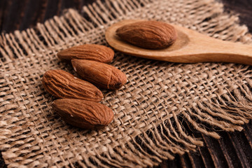 almond essential oil on a wooden background