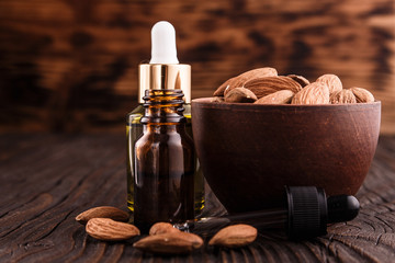 almond essential oil on a wooden background