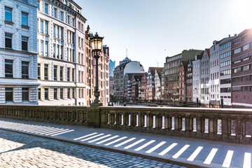 Fototapeta premium historic buildings on both sides of Nikolaifleet canal in Hamburg, Germany on a sunny day