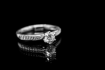 Close up Jewelry diamond ring on black background with reflection