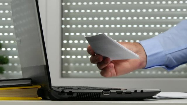 Businessman in Office Read Receipts and Accounting Documents
