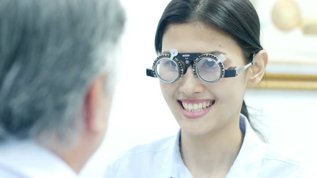 Asian woman test eye glass at clinic. People with healthcare and medical concept. 