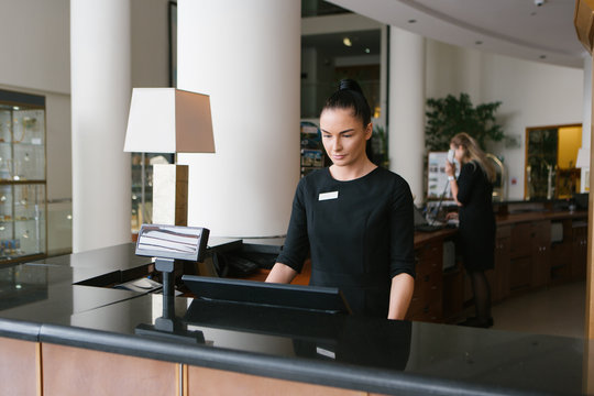 Pretty Hotel Worker Working In Reception