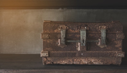 old grungy wooden treasure chest with rusty metal decoration. on Shelves