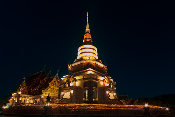 Fototapeta premium People walk with lighted candles to respect Buddha at thailand