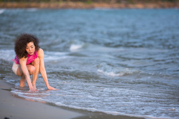 Young mixed race woman on the sea beach.