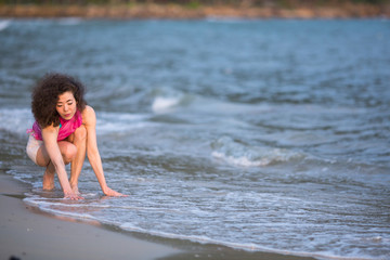 Fototapeta premium Young mixed race woman on the sea beach.