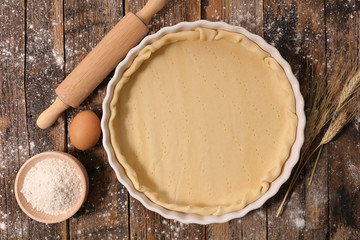 raw dough and rolling pin