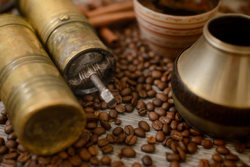 Antique coffee grinder with cup, coffee maker and beans