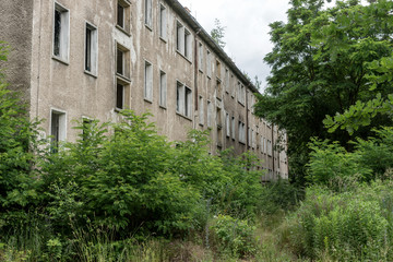 Fototapeta na wymiar Facade of a abandoned multistory building