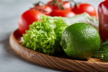 Delicious composition of assorted fresh vegetables and herbs on white textured background, top view, selective focus.