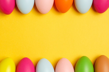 Colorful Easter eggs on a yellow background