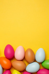 Colorful Easter eggs on a yellow background
