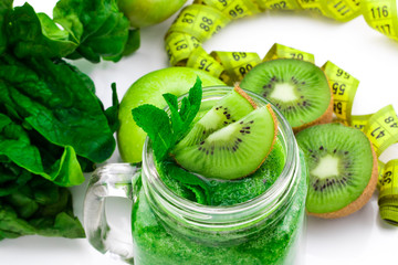 Healthy eating. Green apple, spinach ,green smoothies , measuring tape. Dieting, slimming, weight loss and meal planning concept