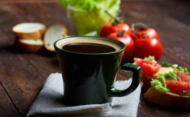 Lunch sandwich with cheese and vegetables served with citrus and coffee, selective focus, close-up, top view