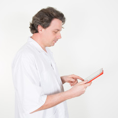 Male doctor using digital tablet in clinic on white background