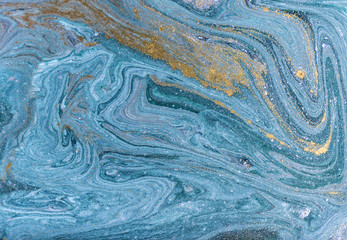 Marble abstract acrylic background. Nature blue marbling artwork texture. Golden glitter.
