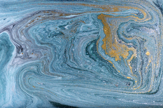 Marble abstract acrylic background. Nature blue marbling artwork texture. Golden glitter.