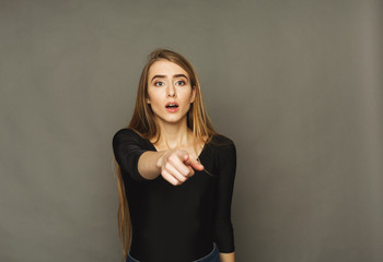 Surprised young woman studio portrait