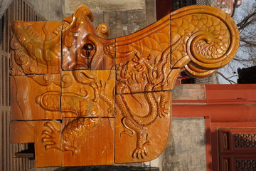 Dragon carved in wood in temple in Beijing China