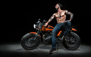 Fototapeta na wymiar Stylish motorcycle chopper with exclusive man rider at night
