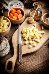 Diced potatoes on a wooden chopping board.