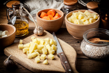 Diced potatoes on a wooden chopping board.