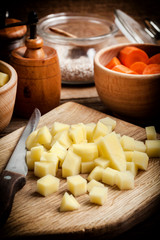 Diced potatoes on a wooden chopping board.