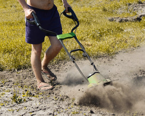Garden manipulator for work. Plowing the site. Garden. The front garden. Lawn. Fertilizer and land...