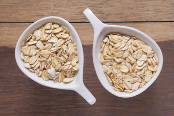 oat flakes in white bowl on wooden table
