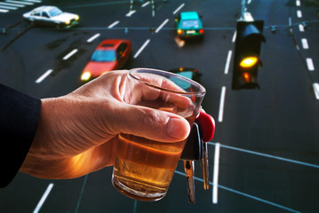 Man Holding Car Key and Glass of Spirits