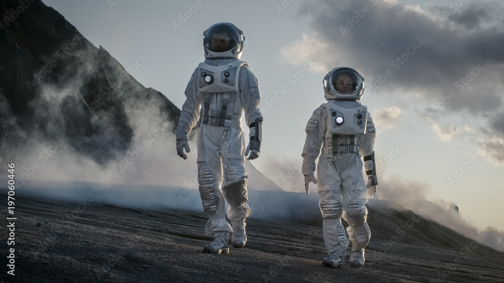 Wall mural two astronauts in space suits confidently walking on alien planet, exploration of the the planet's s