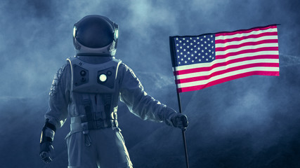 Fototapeta premium Strong Astronaut Walks Through the Storm with a Flag of Unites States of America, Proudly Pants it on the Dark Alien Planet. Space Travel, Colonisation Theme.