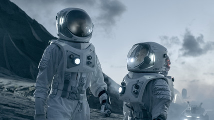 Two Astronauts in Space Suits Confidently Walking on Alien Planet, Exploration of the the Planet's...